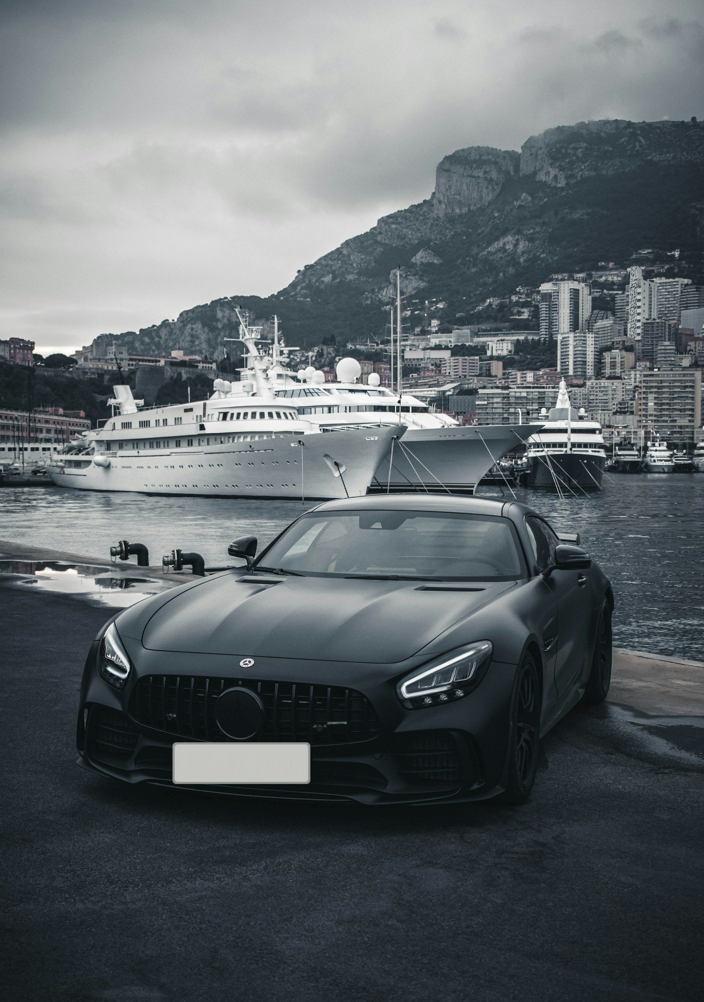 Matte black Mercedes-AMG GT on a harbour front