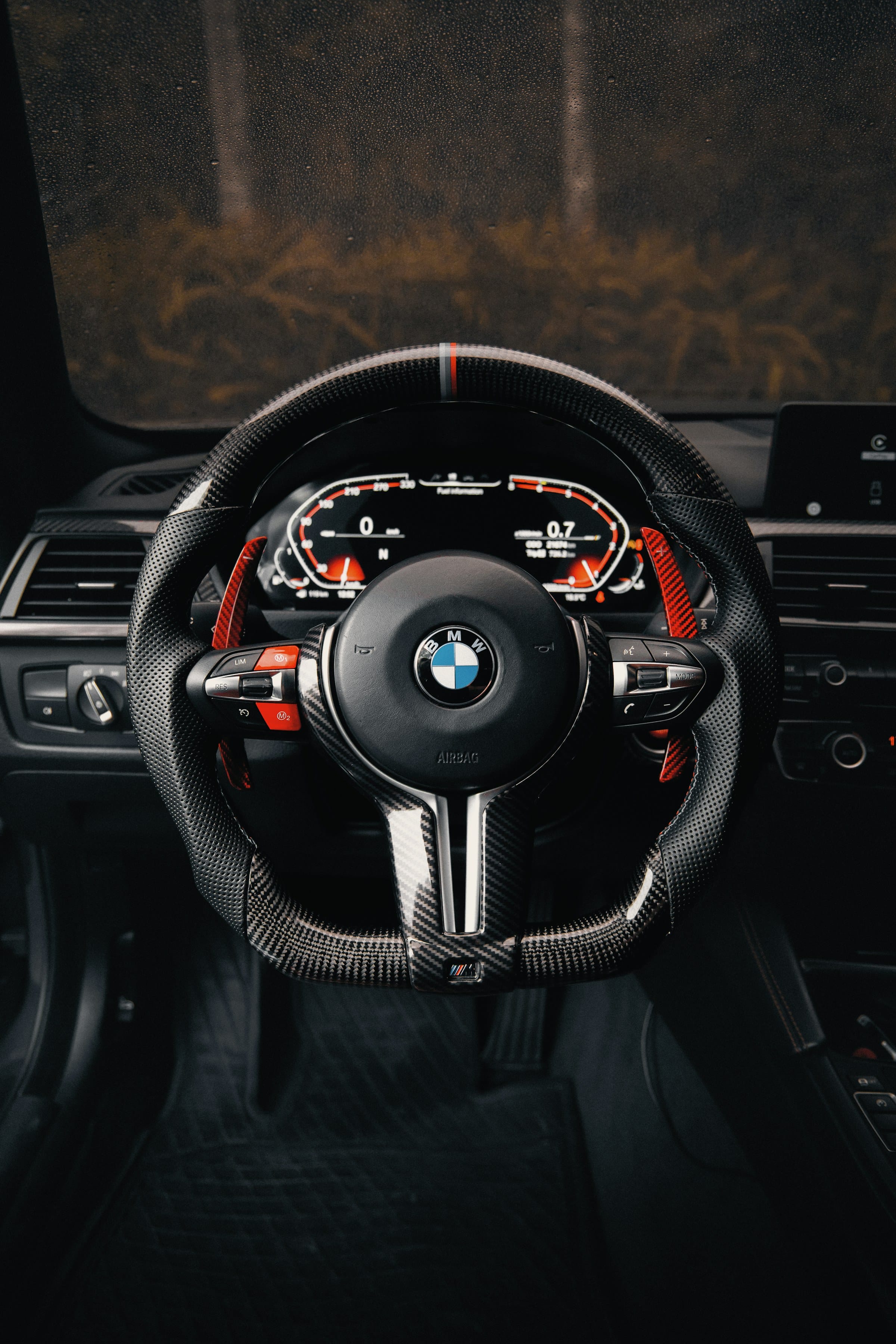 Carbon-rimmed performance steering wheel and digital instrument cluster