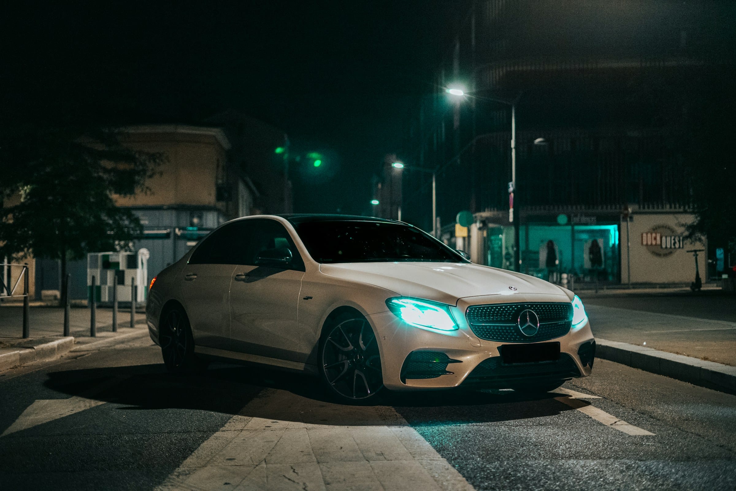 Mercedes-AMG coupe photographed on a wet street at night