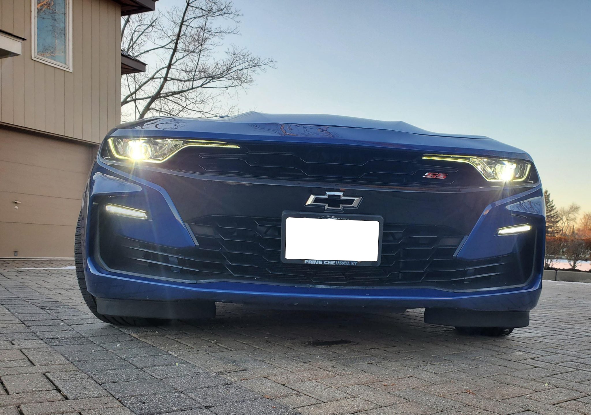 Chevrolet Camaro SS at dusk with headlights lit